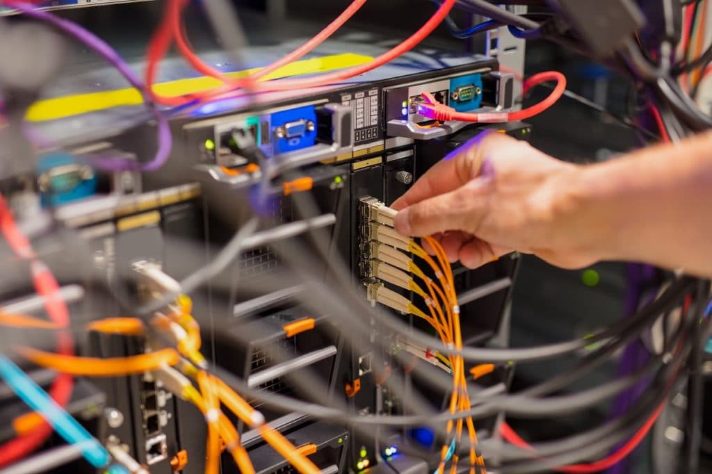 IT Consultant Connecting Network Cable Into Switch