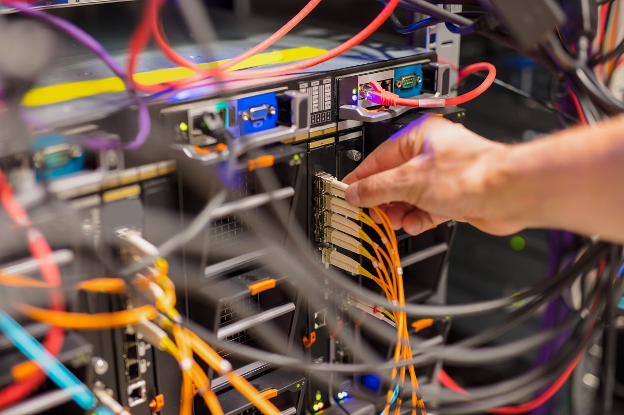 IT Consultant Connecting Network Cable Into Switch